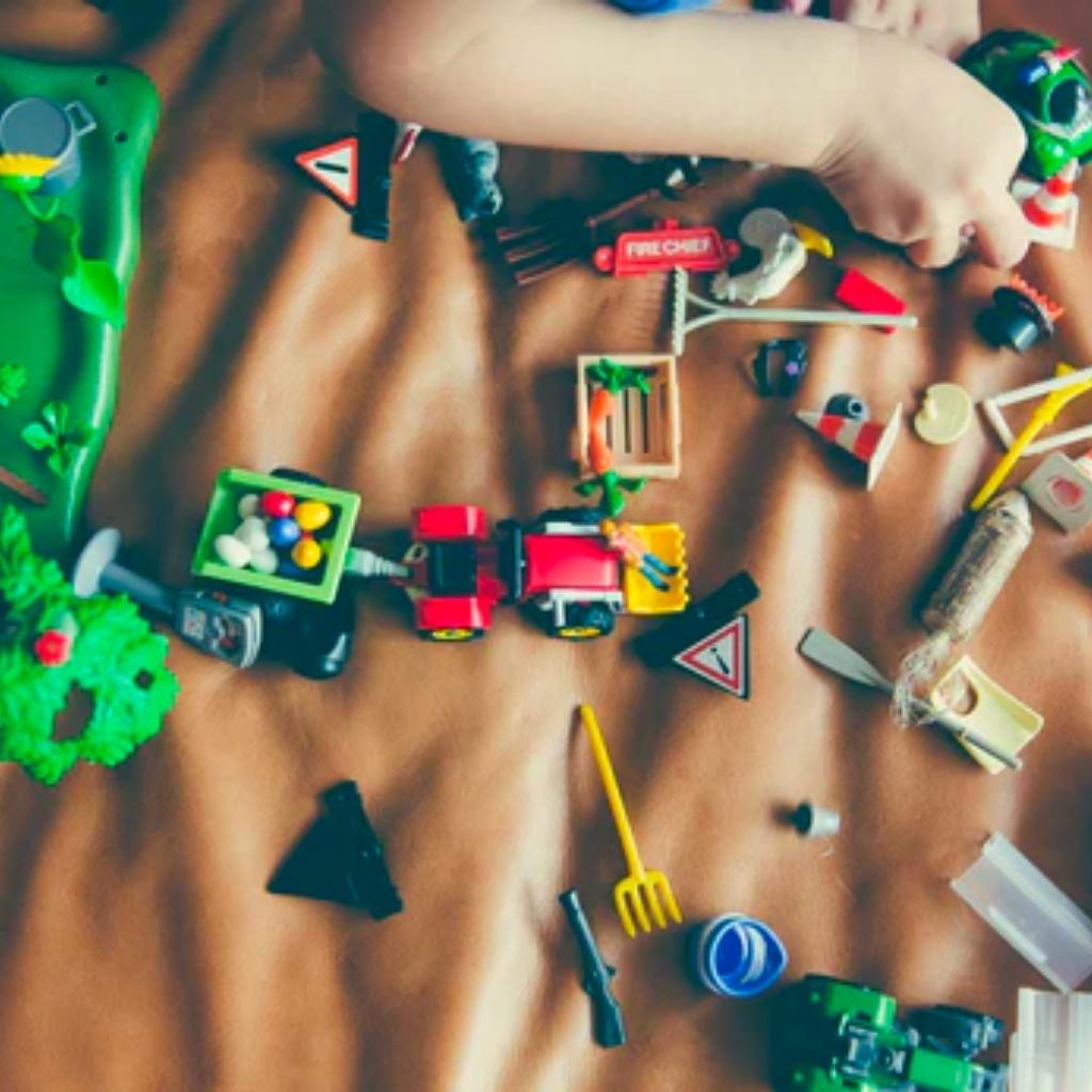 Photo of child playing with toys on a bed, courtesy of Green America