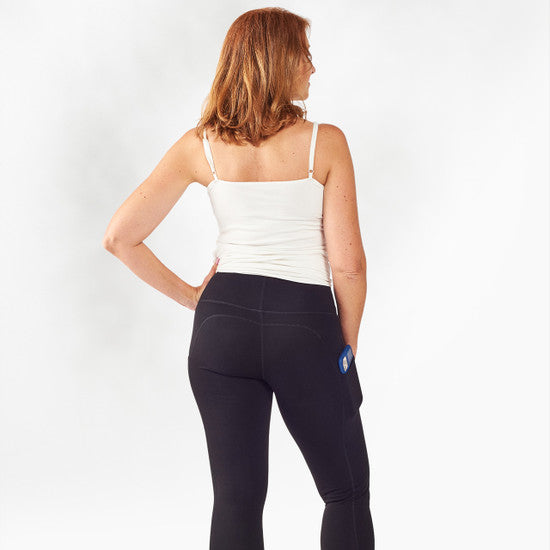 Woman wearing a white top and black leggings on a white background