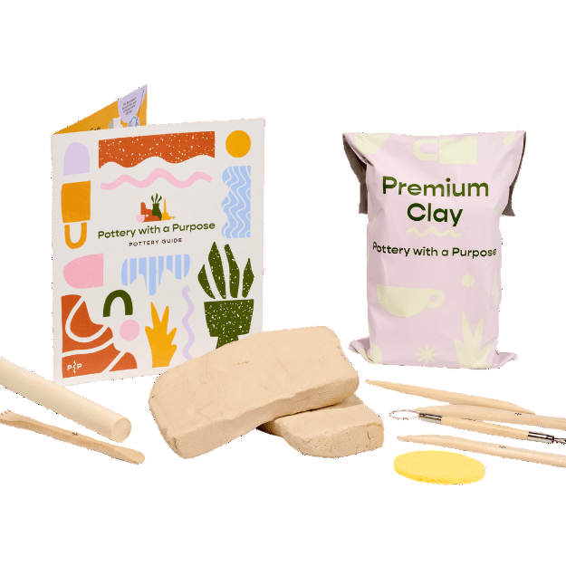 Clay crafting kit with a book, clay blocks, tools, and packaging on a white background