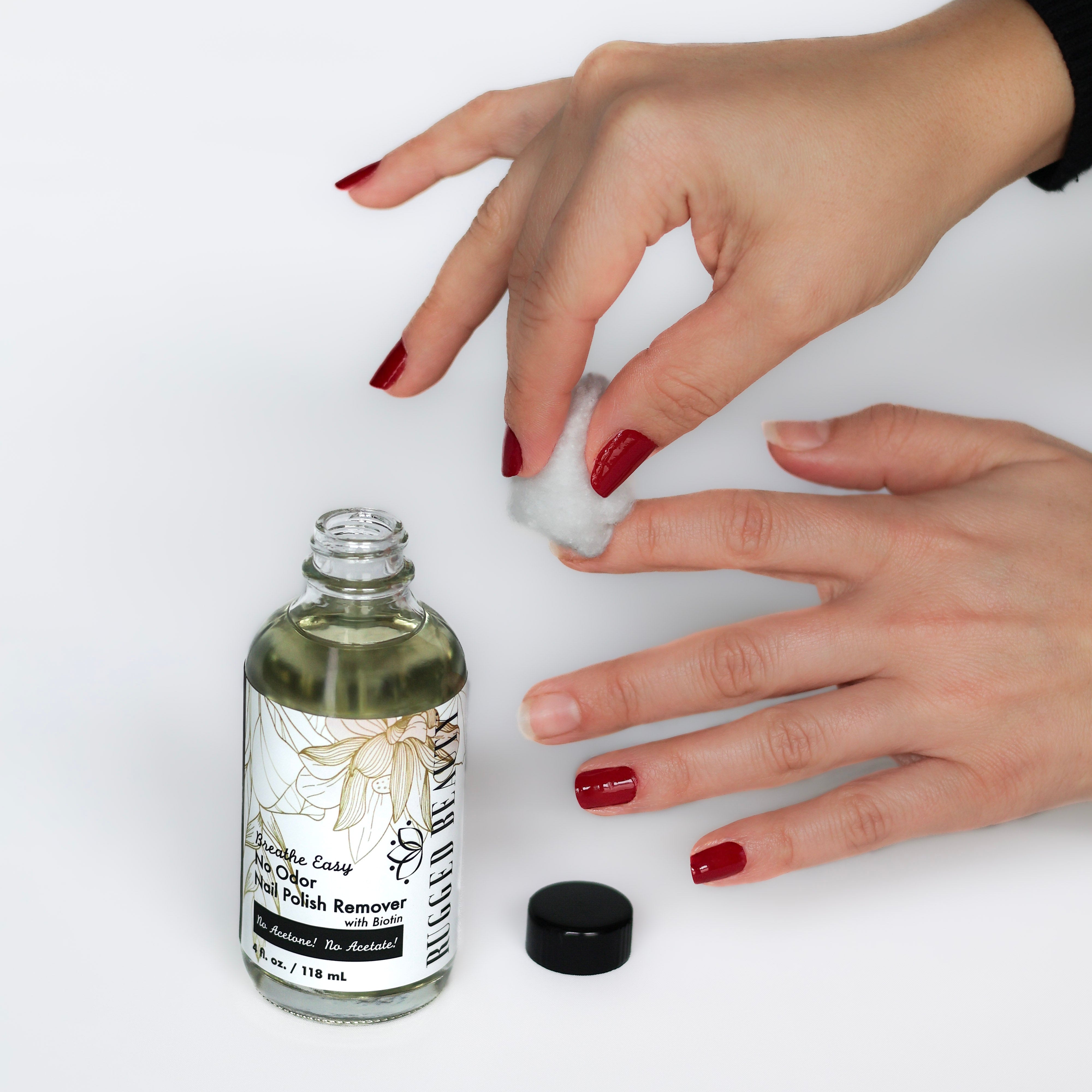 Hand applying a product from a bottle labeled 'Nourishing' on a white background