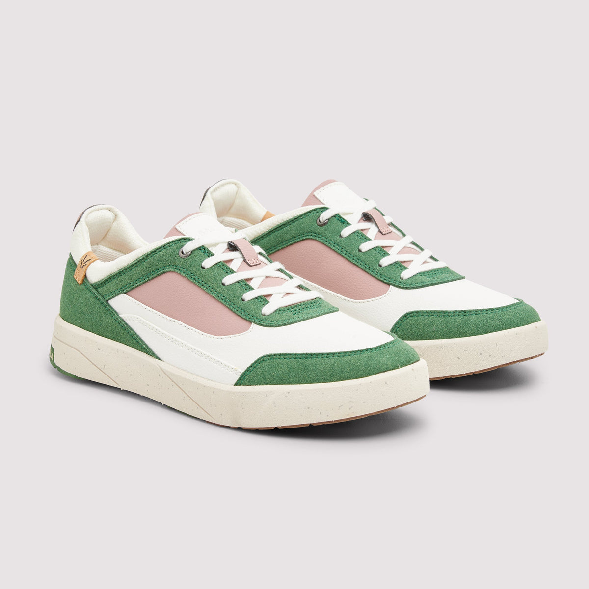 Pair of green and white sneakers with pink accents on a light gray background