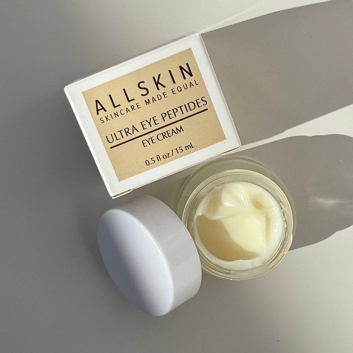 Allskin Ultra Eye Peptides eye cream jar with lid on a gray background