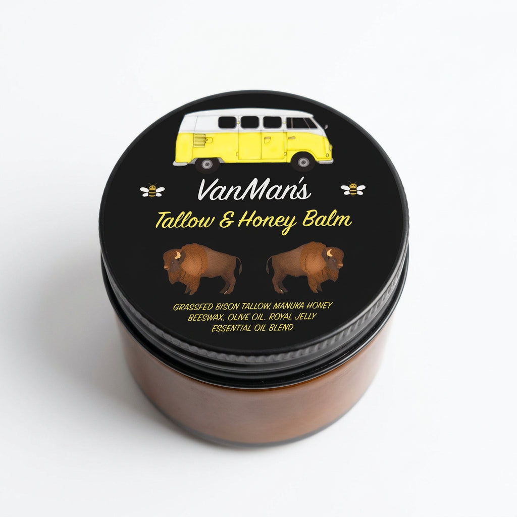 A round tin of Van Man's Tallow & Honey Balm with a black lid featuring a yellow van illustration and bison graphics, set against a warm peach background with diagonal shadows.