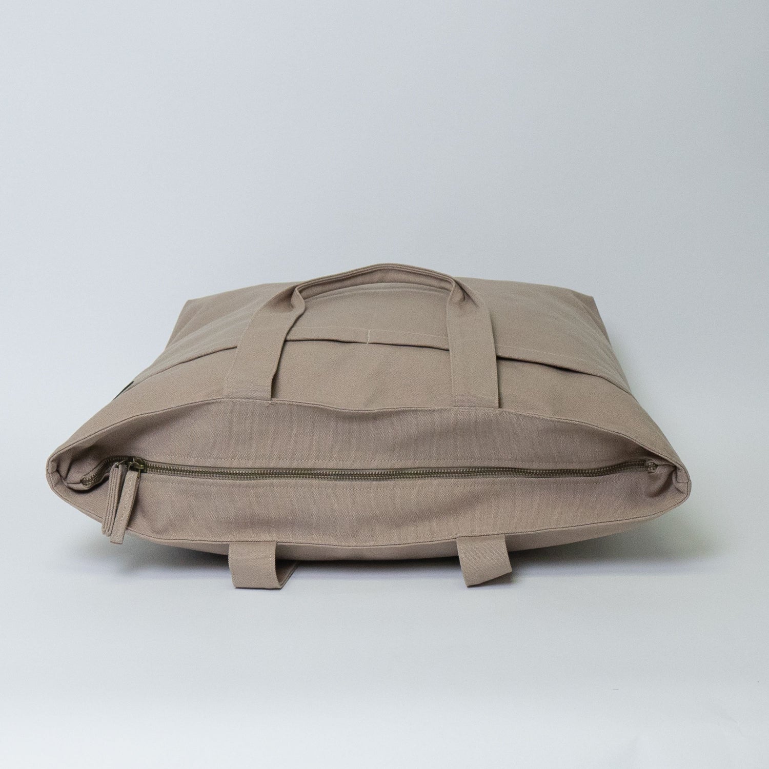 Beige backpack on a light gray background