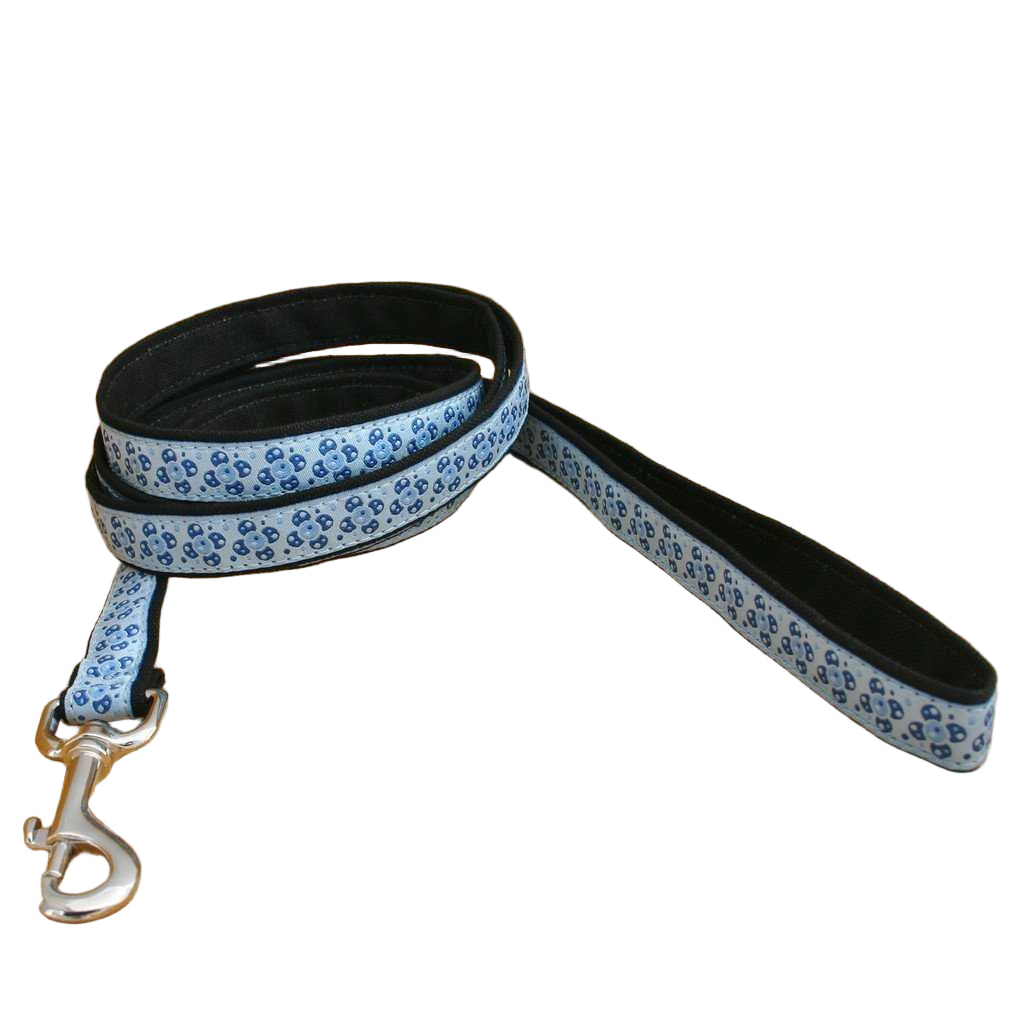 Dog leash with blue paw print pattern on a wooden surface
