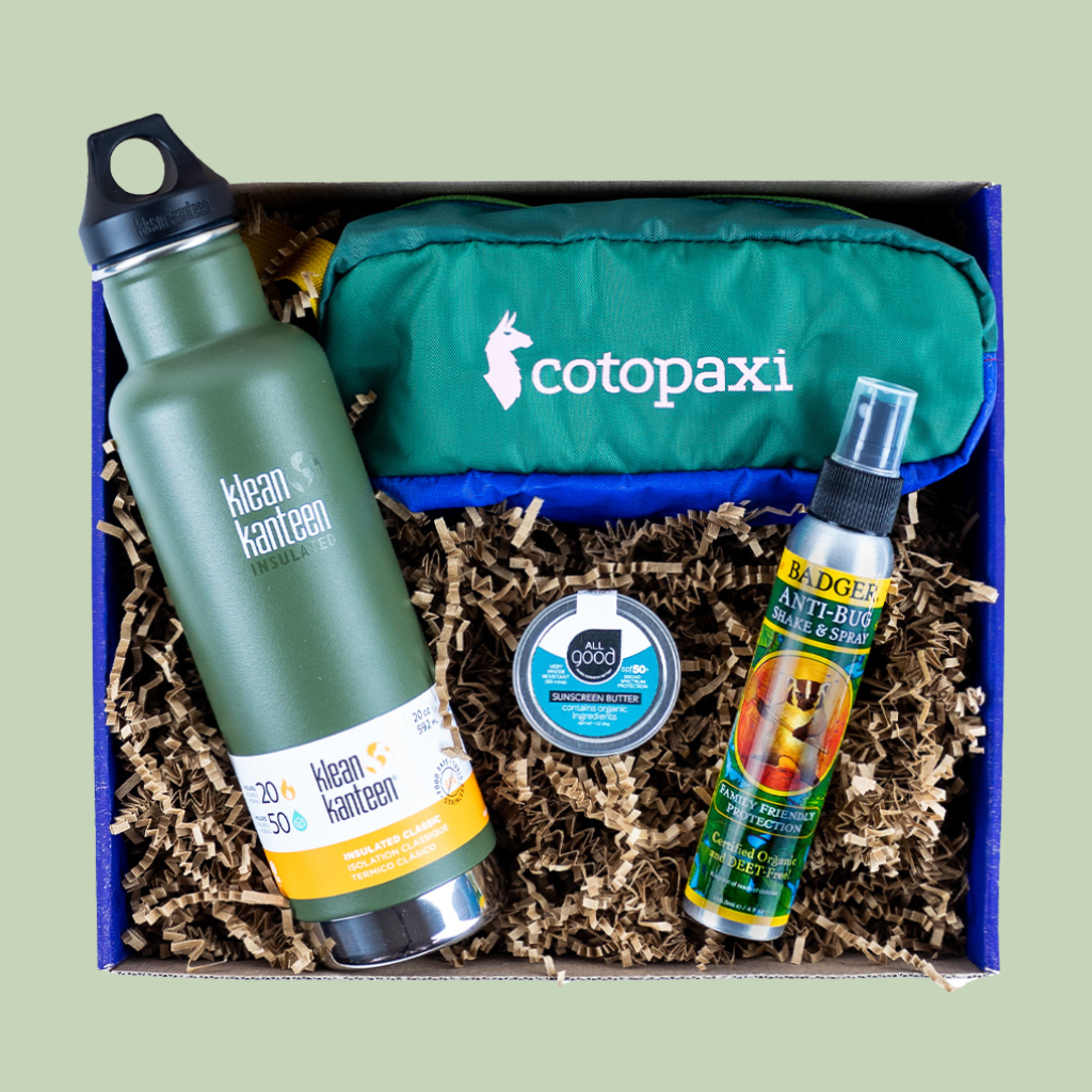 Image of an EarthHero corporate gift box filled with sustainable products like a Klean Kanteen water bottle, a Cotopaxi hip pack, and more