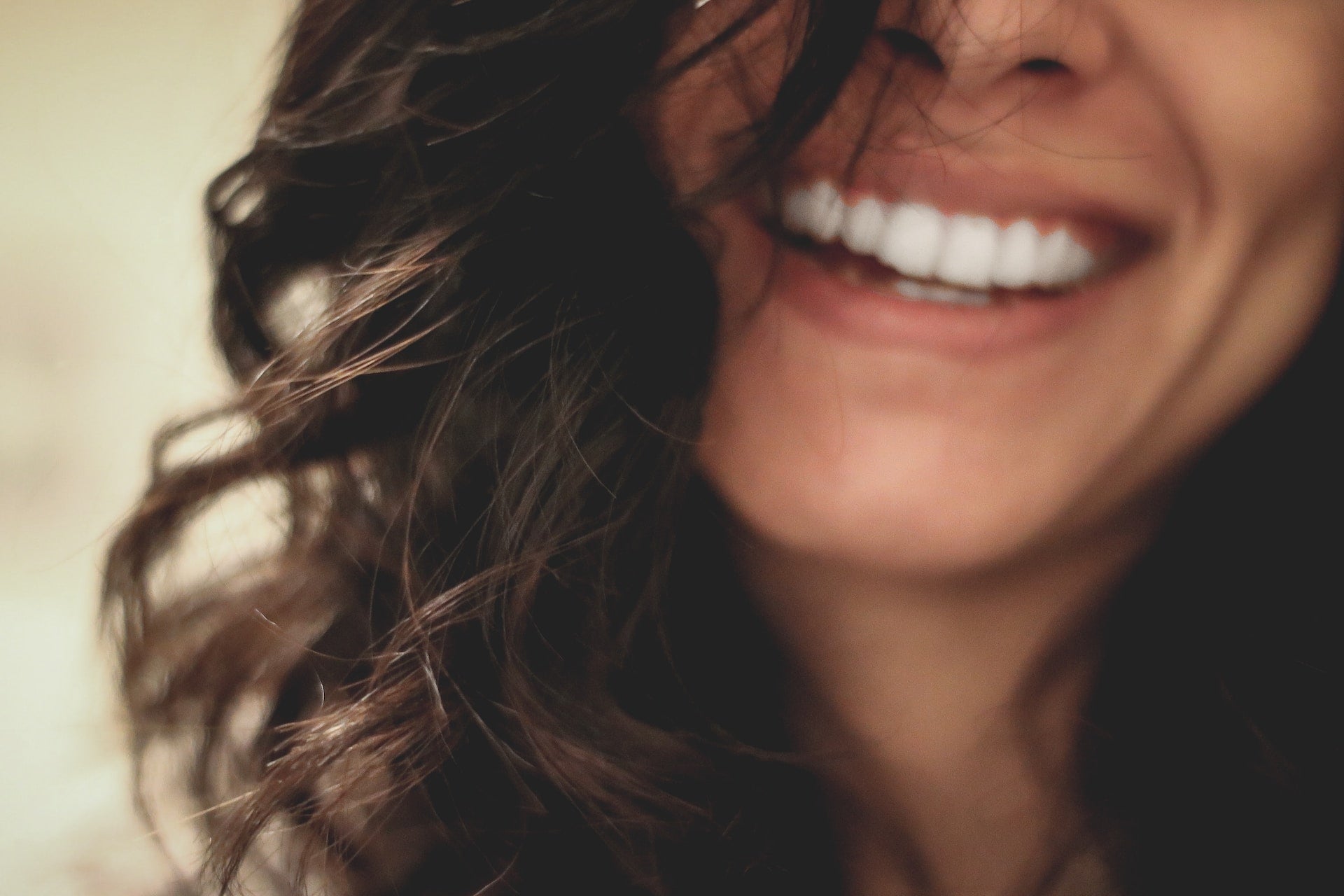 close-up image of a woman smiling.