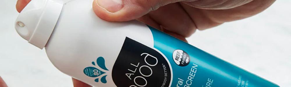 Image of hand holding a spray bottle of All Good Sunscreen