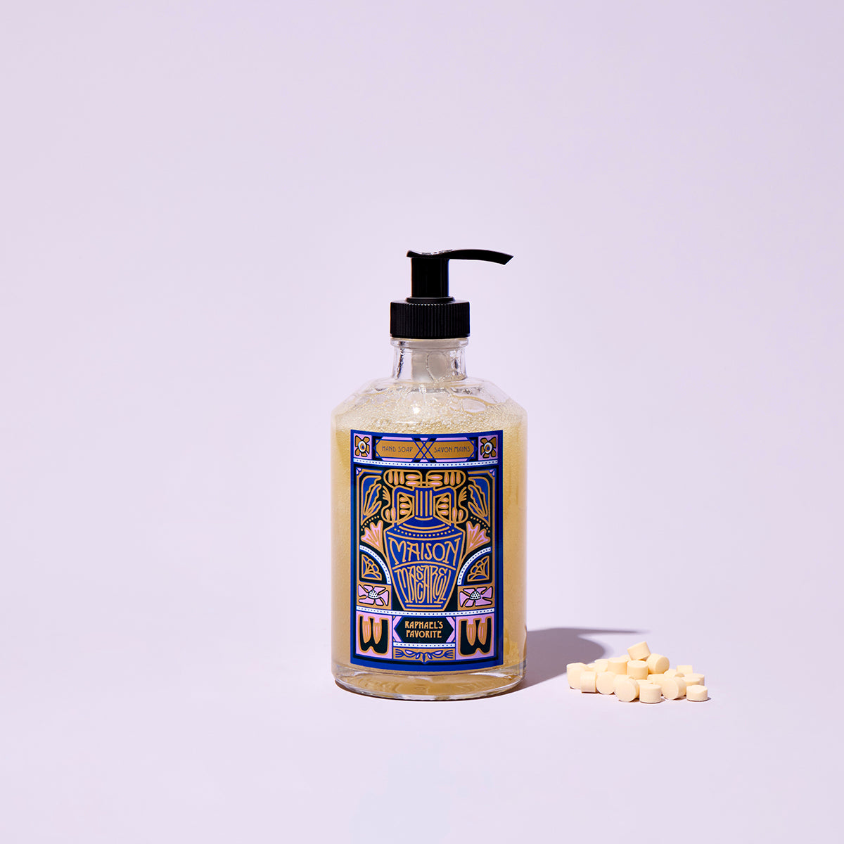 Bottle of soap with a colorful label on a light purple background