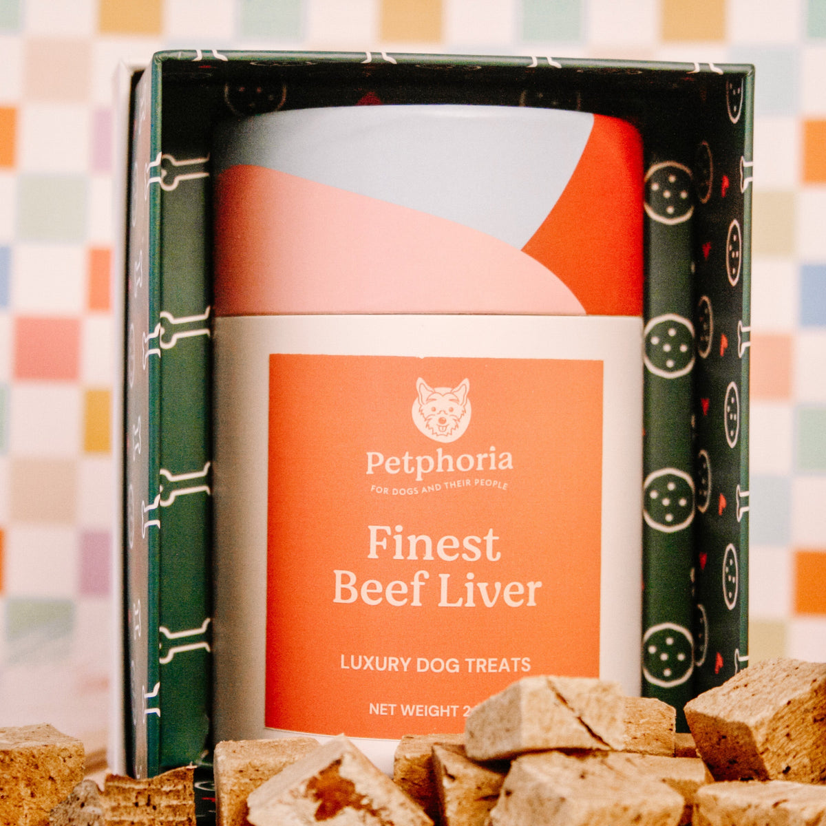 Box of Petphoria Finest Beef Liver dog treats with treats displayed in front on a checkered background