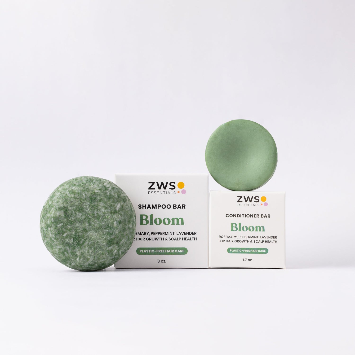 Two green shampoo bars and their packaging labeled 'ZWS Essentials Bloom' on a white background.