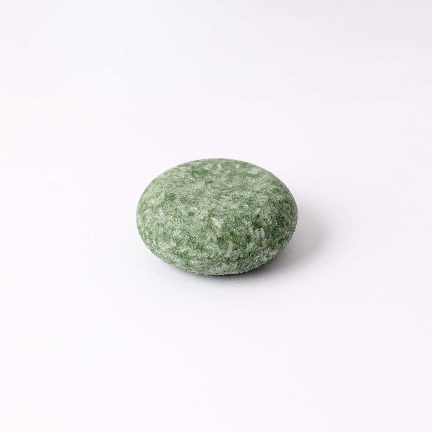 Green shampoo bar on a white background