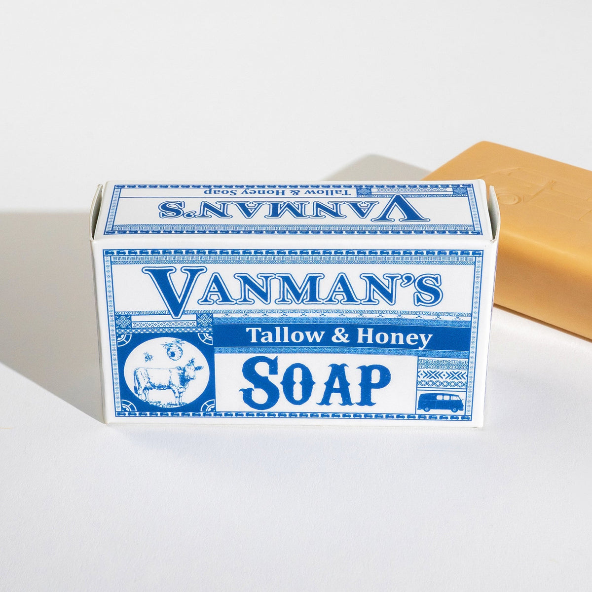 Vanman's Tallow & Honey Soap with a blue and white label on a light gray background