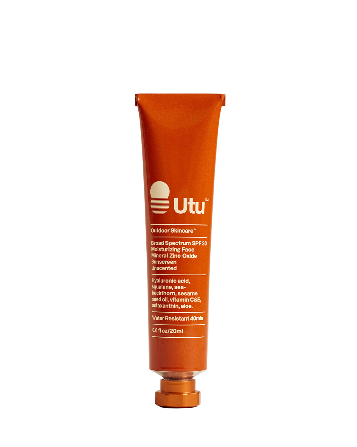 Orange tube of Utu outdoor skincare on a beige background