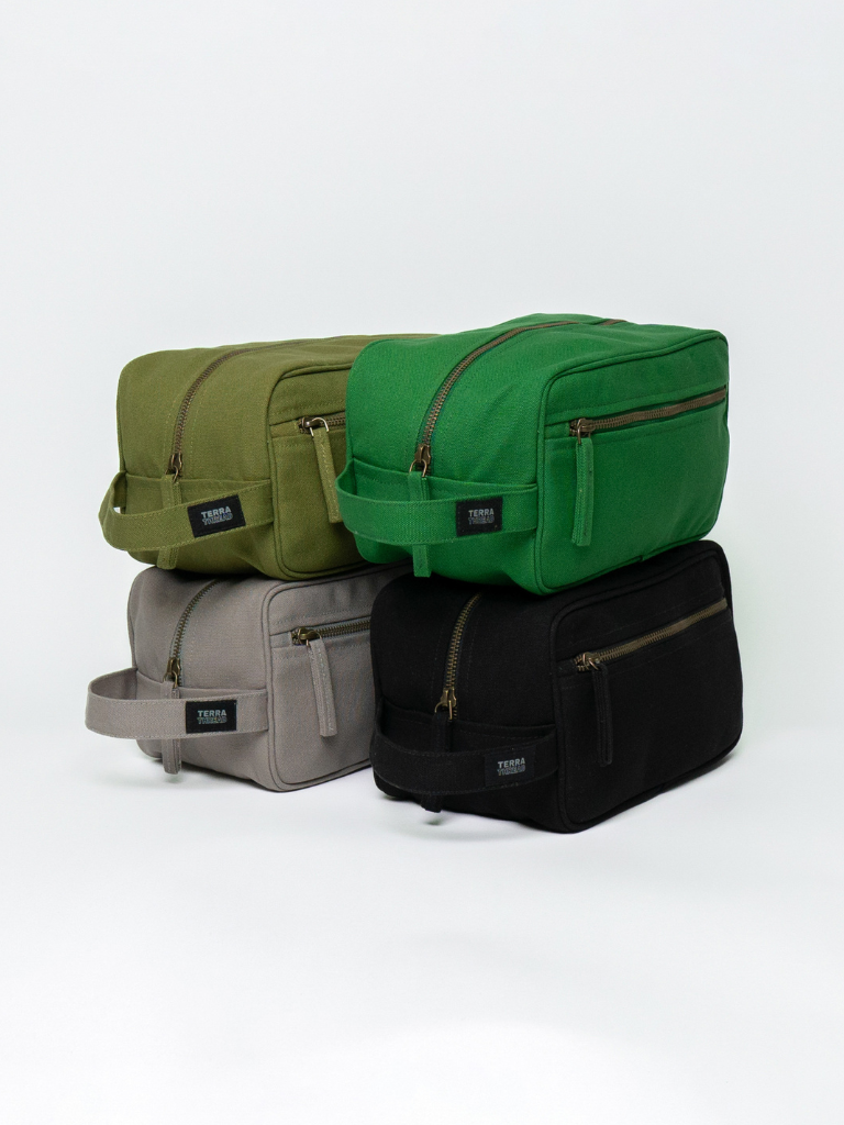 Four green bags of different sizes stacked on a white background