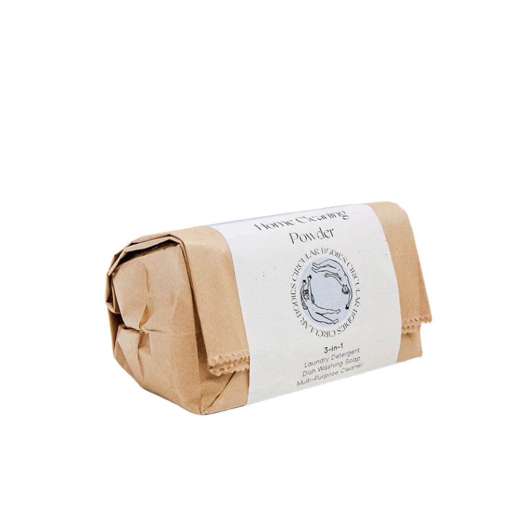 Bar of soap in brown paper packaging with a white label on a white background