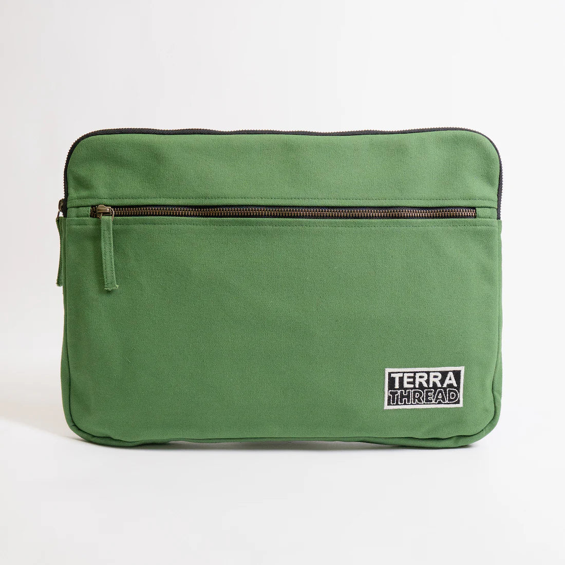 Green laptop sleeve with a visible 'Terra Thread' label on a white background